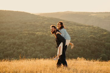 A loving couple is enjoying a wonderfully playful and delightful moment together in a serene sunset...