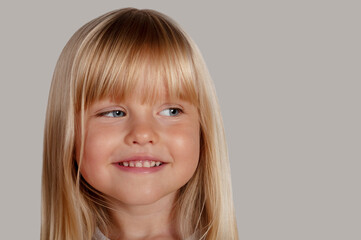 portrait of a happy blond blue-eyed girl 4 years old
