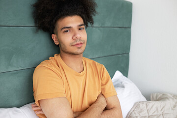 Tips to heal insomnia concept. Portrait of young good-looking black guy with afro hair in orange...