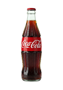 classic coca cola glass bottle with red label on white background

