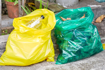 Yellow Bag With Plastic Bottles And Green Bag With Leaves, Ready For Collection
