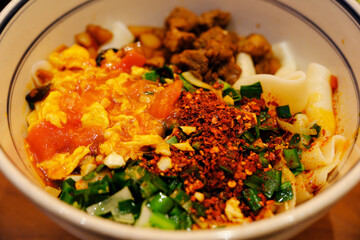 a bowl of Shaanxi style oil-splashed noodles, Chinese food