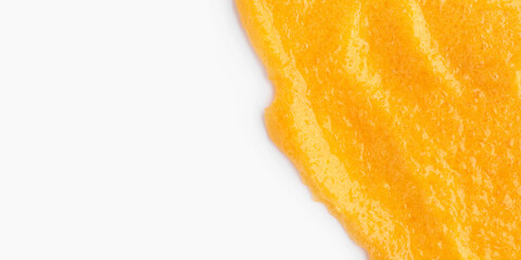 The texture of a orange body scrub with particles. Close-up