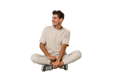 Young caucasian man sitting on the floor isolated on white background looks aside smiling, cheerful and pleasant.