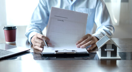 cagents working in real estate investment and home insurance signing contracts in accordance with the home buying insurance agreements approving purchases for clients