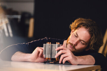 Engineer working on technological device at home loft workspace