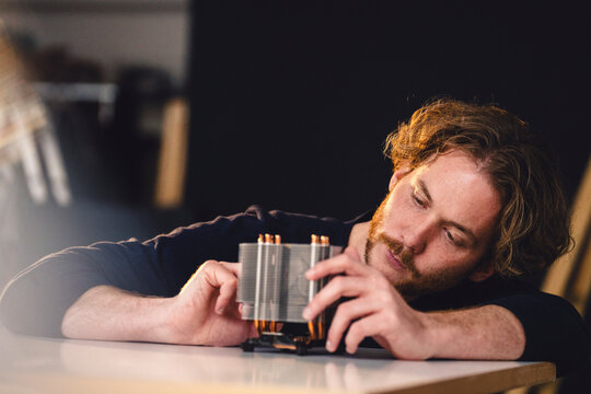 Engineer working on technological device at home loft workspace