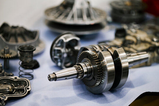 Gear shaft and engine components in workshop for vehicle repair