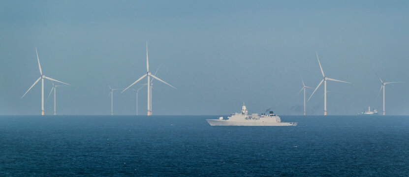 Dutch navy ship patrolling near offshore windfarm on the North Sea