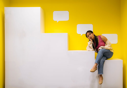 Woman posing on modern white staircase with casual style
