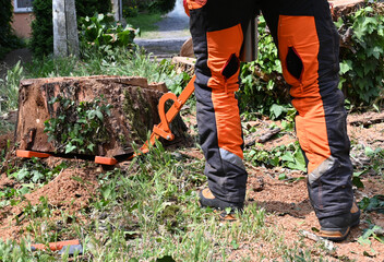 Tree stump removal in a residential yard with a worker using specialized equipment