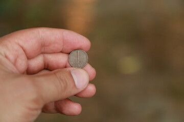 Hand holding few small Dutch coin
