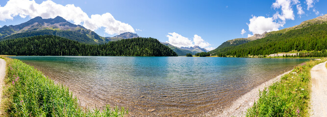 Panorama of the lake and the village of Silvaplana, on a summer's day, and the surrounding mountains.