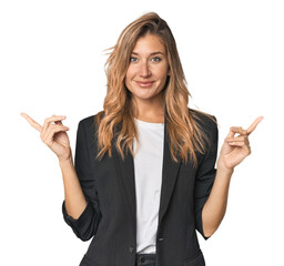 Young businesswoman in a suit pointing to different copy spaces, choosing one of them, showing with finger.