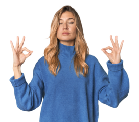Caucasian blonde woman in studio relaxes after hard working day, she is performing yoga.
