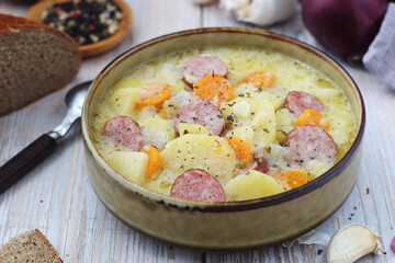 A bowl with traditional German potato soup with sausages