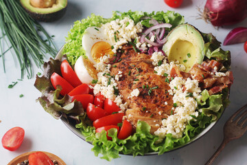 A bowl with cobb salad, traditional American dish