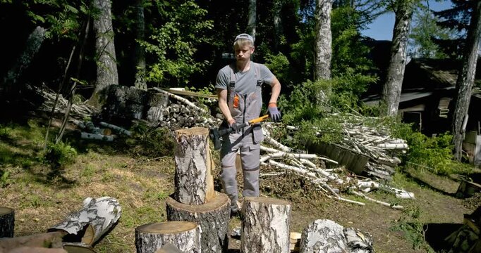 Man Splitting Large Birch Logs with Axe Outdoors in Sunny Forest Area, Chopping Firewood for Winter, Dynamic Action Scene with Wood Chips Flying, Stack of Birch Firewood and Tree Trunks in Background