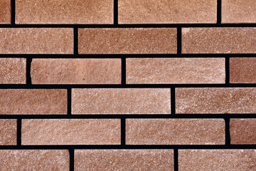 Brick wall facade with brick-effect cladding, construction material.