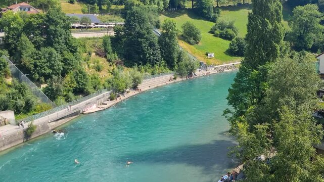 View of the turquoise Aare River and the B&auml;rengraben bear enclosure in central Bern, Switzerland, on a sunny summer day