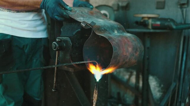 Traditional coppersmith workshop for copper brewing pots manufacturing. This handmade brewery kettles will be used for making traditional alcohol brandy drinks. Small traditional business concept.