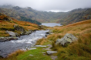 Mountain lake vista in autumn.  Stream flows through a valley
