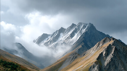 Fototapeta premium A breathtaking view of majestic mountains shrouded in mist, showcasing the beauty of nature and the grandeur of rocky peaks.