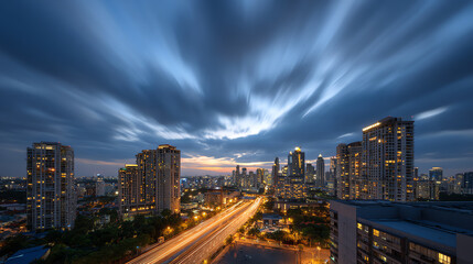 Stunning city skyline at dusk, showcasing modern architecture against a dramatic sky with moving clouds and vibrant lights.