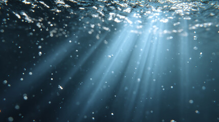 Underwater scene showcasing shimmering light rays filtering through water, creating a serene and tranquil atmosphere.