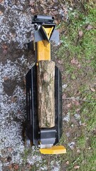 Log Splitter Machine Preparing Firewood Outdoors in Winter