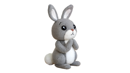 Gray crocheted bunny with white belly and tail isolated on a transparent background