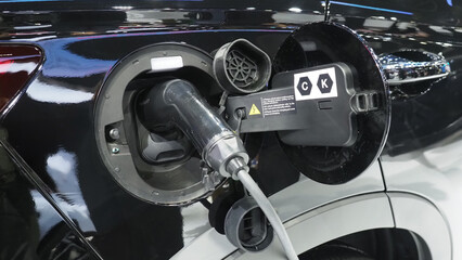 an electric vehicle charging port with a plugged in charging cable