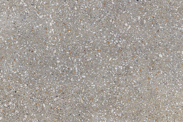 abstract background of decorative concrete texture filled with pebbles close up