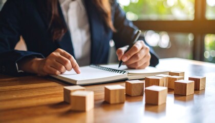 Brainstorming session featuring a businesswoman creating strategic plans with wooden blocks