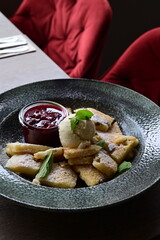 Traditional Austrian Kaiserschmarrn served with sour cherry sauce and a scoop of vanilla ice cream.