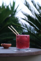 Blueberry cocktail under dim lighting © onur