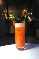 Strawberry mojito on the table. Strawberry drink in the cafe at night.