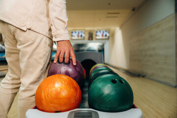 Fototapeta premium Taking the ball. Close up view of man that is playing bowling