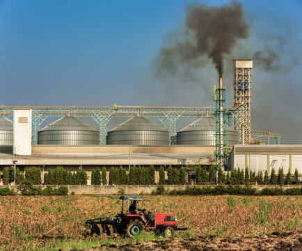 Agricultural silos with thick smoke from pipe emissions pollutio