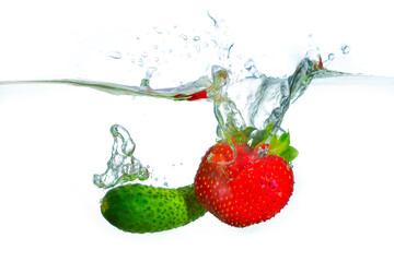 Fresh Cucumber And Strawberry Splashing In Clear Water