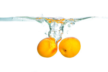 Fresh Apricots Splashed Into Clear Water Creating Dynamic Ripples