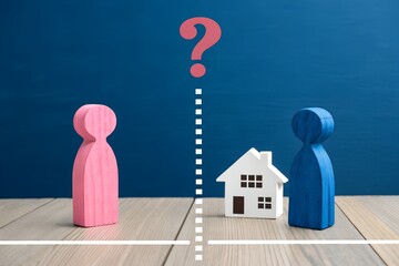 Divided Connection – Pink and Blue Wooden Figures Separated by Dashed Line and White House with Question Mark Symbol, Abstract Relationship and Decision Concept on Blue Background