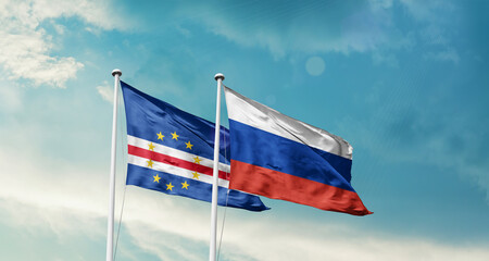 Cabo Verde and Russia friendship flags are waving in the sky. Double country Flag waving with mast. Cabo Verde Russia national flag for agreement.