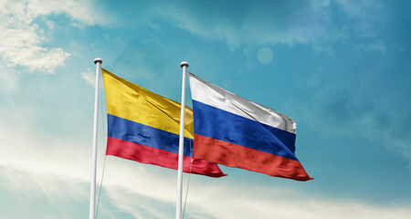 Colombia and Russia friendship flags are waving in the sky. Double country Flag waving with mast. Colombia Russia national flag for agreement.