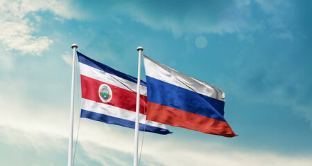 Costa Rica and Russia friendship flags are waving in the sky. Double country Flag waving with mast. Costa Rica Russia national flag for agreement.