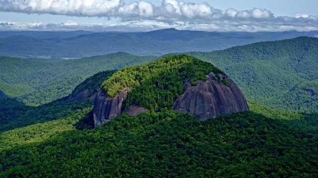 Cinematic aerial footage of a single dominant mountain set apart from its neighbors.