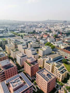 Aerial view of the The Paris 2024 Olympic and Paralympic Village with solar panels contrasting against the distant urban skyline, Village des Athl&Atilde;&uml;tes Olympiques, &Atilde;Žle-de-France, France.