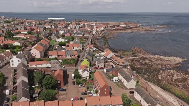 Aerial video of Dunbar seafront buildings and harbour in East Lothian, Scotland