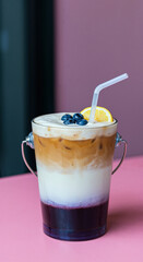 Coffee Bucket with Blueberry and Orange Slice on Pink Table