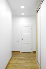 White interior doors in the white corridor